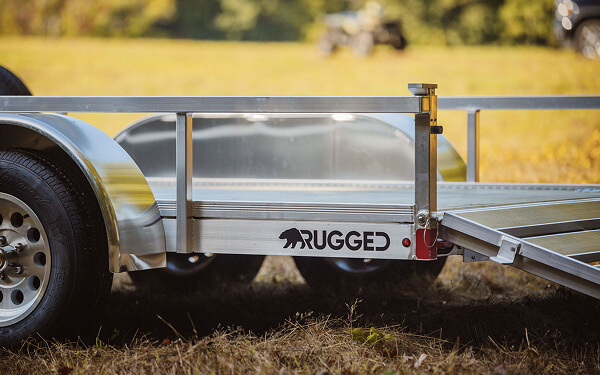 Tilt decks and long ramps improve safety by lowering the loading angle for mowers and compact equipment. Safer loading reduces equipment damage and helps crews maintain a consistent workflow across multiple sites. Photo Credit: Rugged Aluminum Trailers