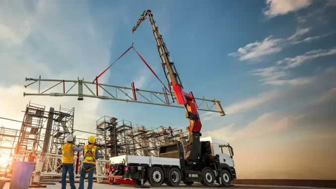 Knuckle boom cranes use an articulated boom with multiple jointed sections, allowing them to fold compactly and reach into tight or obstructed spaces that straight boom cranes cannot access. They are widely used across construction, logistics and utility work because their precise load control and compact setup footprint improve efficiency and reduce repositioning on crowded job sites. Photo Credit: PALFINGER AG