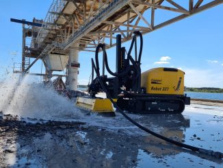 Hydrodemolition robots remove deteriorated concrete using high-pressure water without causing vibration or microcracking in surrounding material. This makes them well suited for bridge decks and dam structures where structural integrity must be preserved. Photo Credit: Conjet