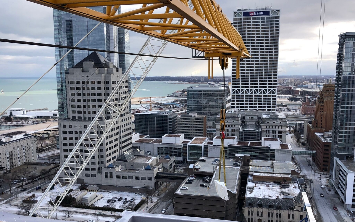 Tower crane assembly and dismantling depend on precise scheduling and weather windows. Missing these windows can halt structural progress and disrupt multiple downstream trades. Photo Credit: Reynolds Rigging & Crane Service, Inc.