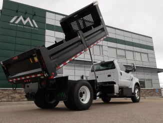 Steel dump bodies are commonly selected for asphalt and aggregate hauling because they offer higher impact resistance and durability in abrasive environments. Material choice directly affects both service life and maintenance intervals. Photo Credit: Industrial Machine Inc.
