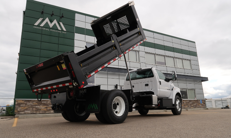Steel dump bodies are commonly selected for asphalt and aggregate hauling because they offer higher impact resistance and durability in abrasive environments. Material choice directly affects both service life and maintenance intervals. Photo Credit: Industrial Machine Inc.