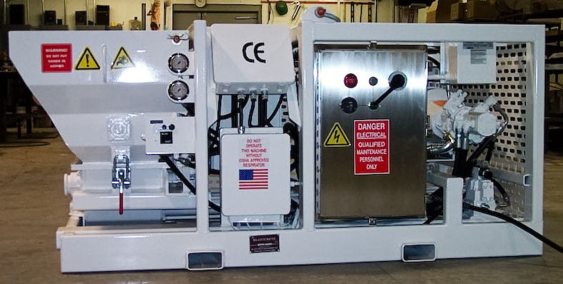 White Blastcrete high-pressure shotcrete pump with swing-out hopper in a shop setting
