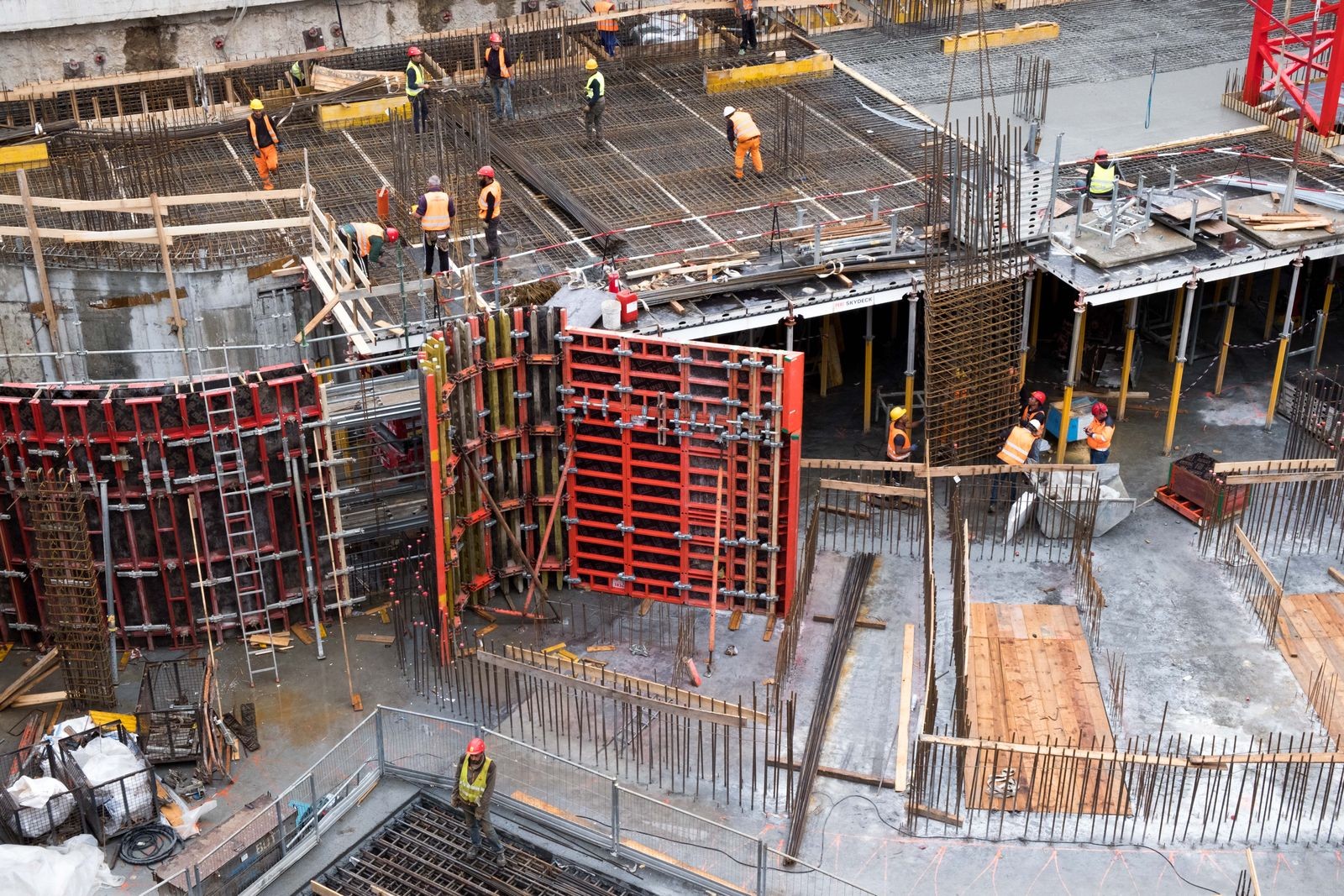 Aerial view of construction formwork with dense rebar mats and column cages before a concrete pour
