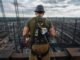 Worker in FrenchCreek fall safety harness with dual SRLs on steel frame
