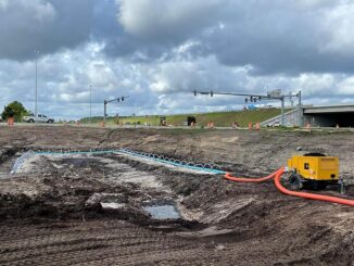 Yellow trailer pump with blue wellpoint header for dewatering