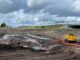 Yellow trailer pump with blue wellpoint header for dewatering