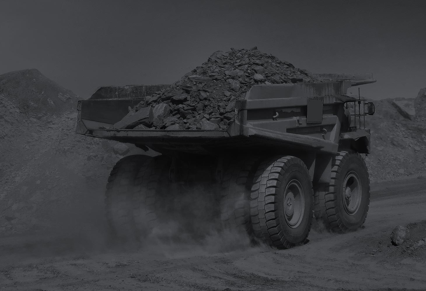 Open-pit earthmoving site with haul roads and loading areas where cycle length drives tire heat