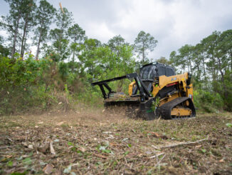 Skid-steer depth-control drum mulcher working brush on a compact track loader