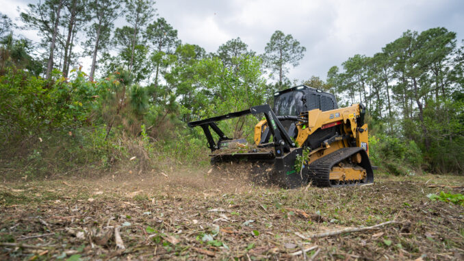 Skid-steer depth-control drum mulcher working brush on a compact track loader