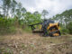 Skid-steer depth-control drum mulcher working brush on a compact track loader