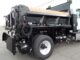 Black PB Loader asphalt patching truck showing rear emulsion tank, hose, and controls