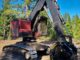 Black Rockland Krypto-Klaw grapple attachment on red tracked forestry machine in a pine clearing
