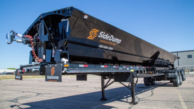 Black side dump trailer for construction material hauling
