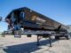 Black side dump trailer for construction material hauling