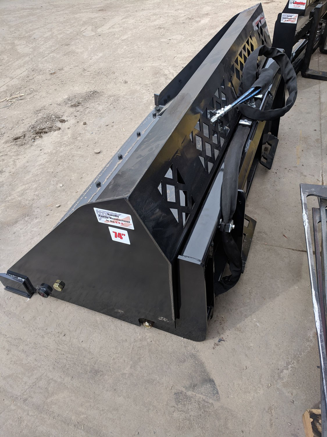 Top-rear view of high-dump bucket showing pivot frame, visibility screen, and hydraulic hoses