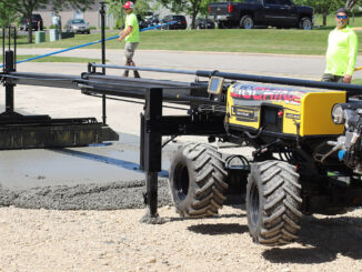 Laser-guided boom screed placing commercial flatwork for FF/FL control