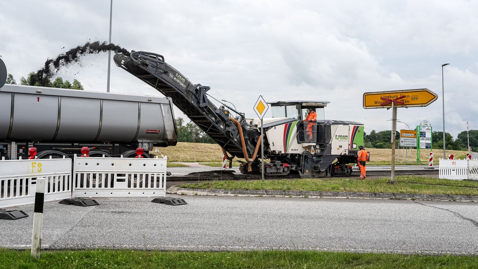 Cold milling machine loading reclaimed asphalt into a dump truck