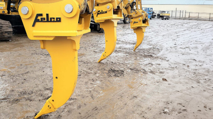 Yellow Felco excavator ripper shanks in equipment yard