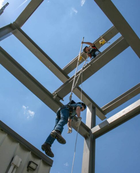 Workers demonstrating FrenchCreek fall-arrest and rescue on steel frame